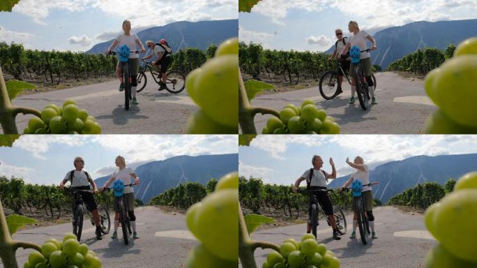 成熟的骑自行车的夫妇探索葡萄园和山脉