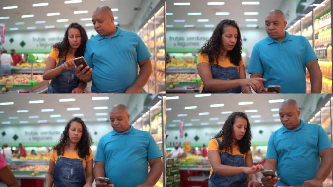 在超市购物时使用智能手机的家庭
