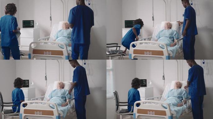 一名老年男性患者床边的非洲民族医疗队。关怀医疗保健提供者监视一名老年男性医院患者的生命体征