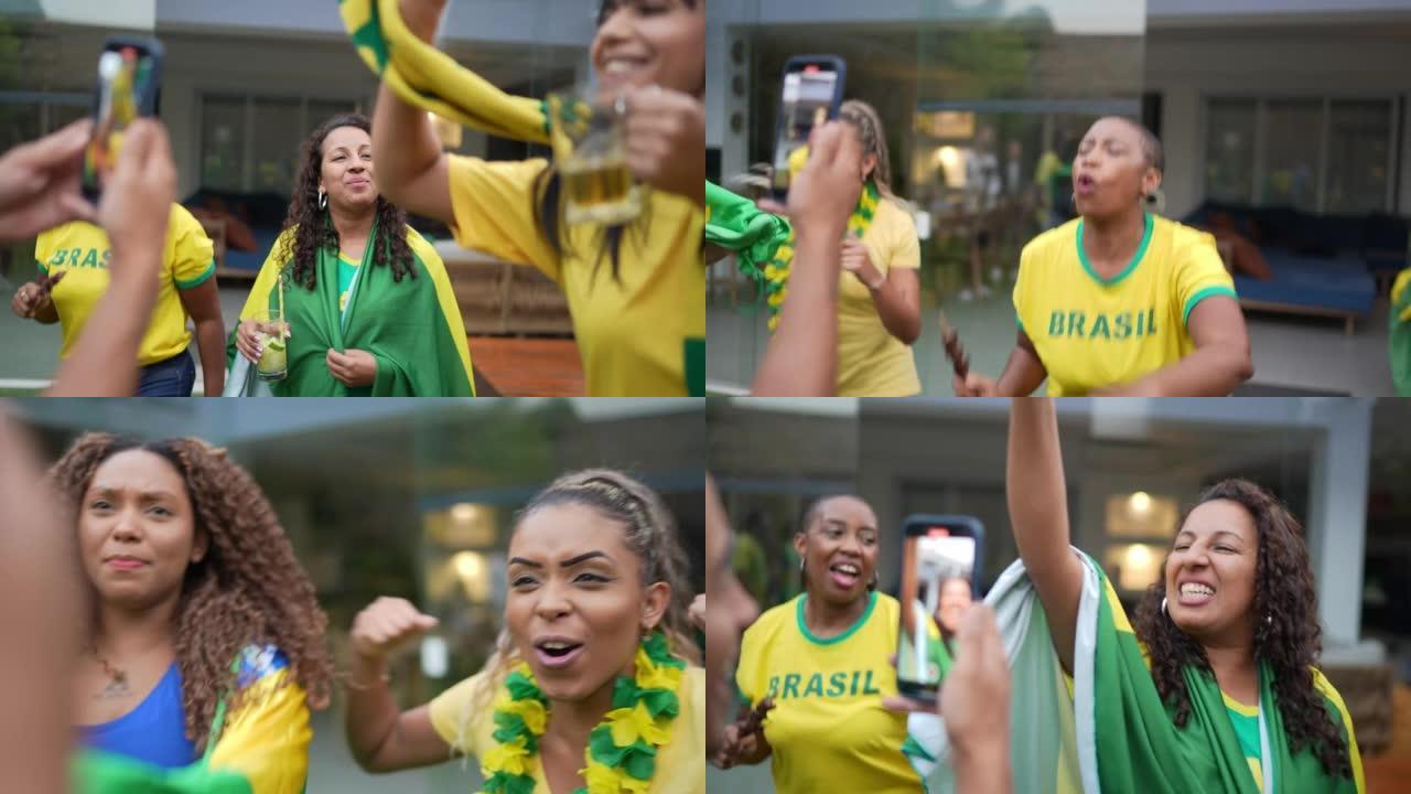 巴西体育迷在庆祝时在智能手机上拍摄