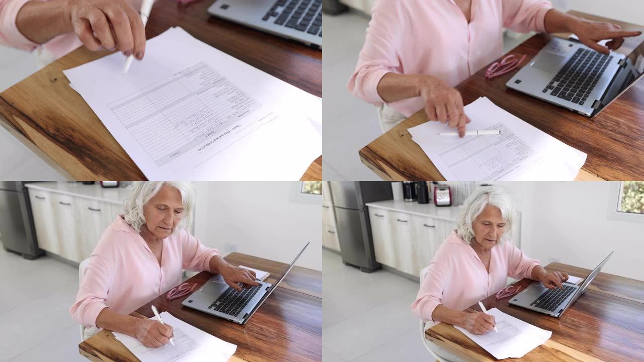企业家高级妇女用笔记本电脑列出客户名单，在家工作时在纸上写字