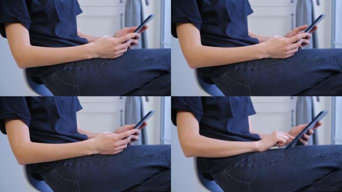 年轻女子浏览平板电脑应用程序在特写镜头。女性在连接到快速无线互联网的便携式小工具上上网