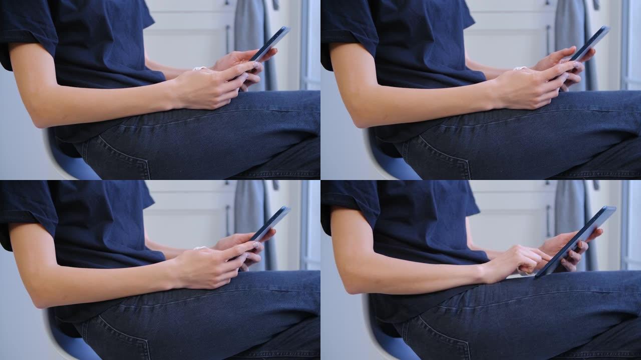 年轻女子浏览平板电脑应用程序在特写镜头。女性在连接到快速无线互联网的便携式小工具上上网