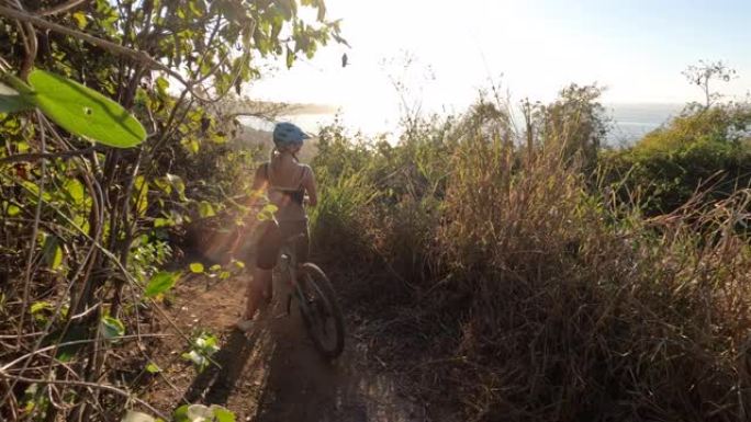 沿着丛林树冠和女性骑自行车的路径查看