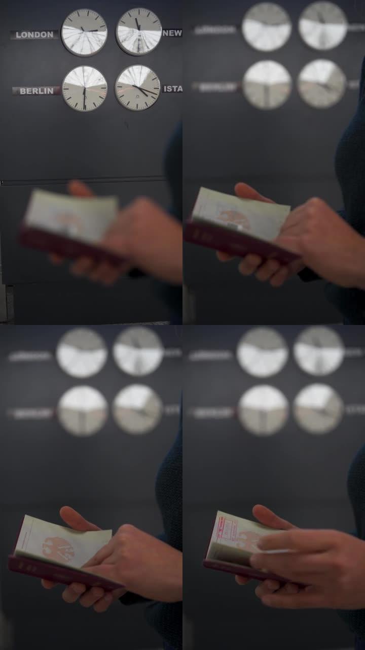 一名妇女在大型世界时钟前的机场里翻阅德国护照的垂直细节镜头