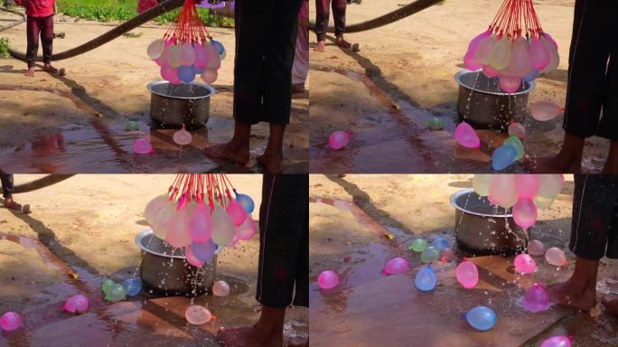 女孩们在阳光明媚的日子里给水球充气。暑期趣味儿童户外活动概念