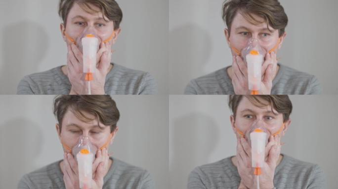 使用雾化器服用药物的白种病白种人的特写镜头。用吸入器治疗支气管炎或哮喘的男性患者的头像。治疗理念。