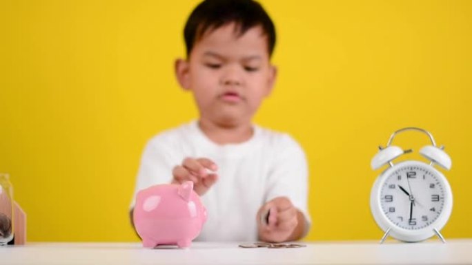 Save money Asian boy in white shirt is saving coin