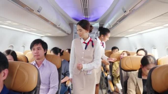 4k亚洲女空姐在飞机起飞跑道前关闭行李舱。