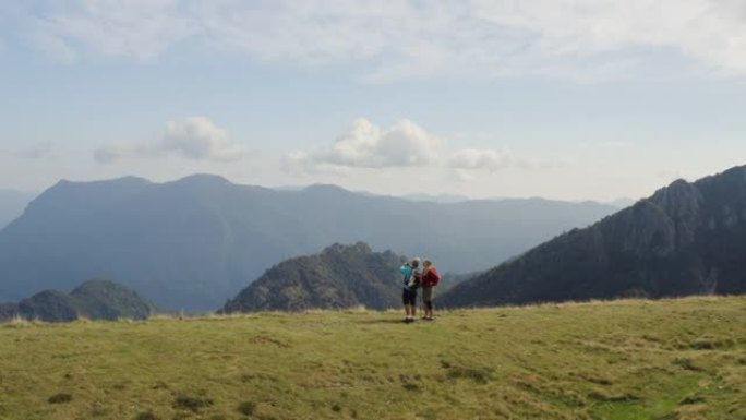 一对夫妇的空中无人机拍摄在山上徒步旅行时停下来欣赏风景拍照