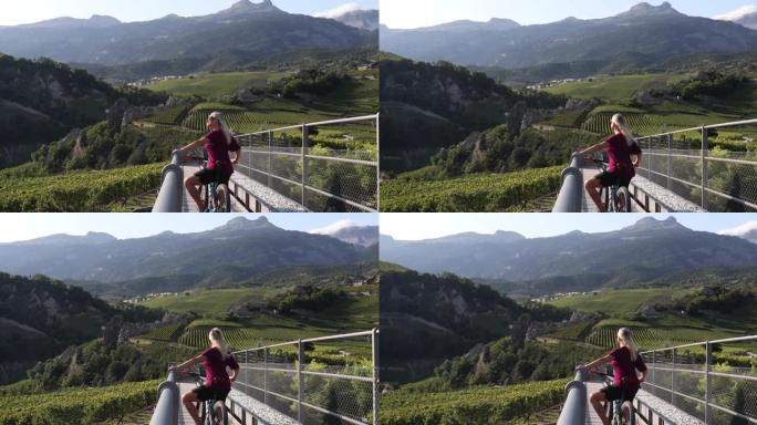 女人在葡萄园边缘放松，骑自行车