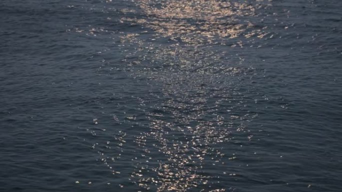 The light of the moon is reflected on the sea surf