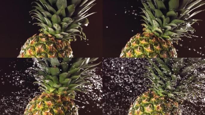 超级慢动作水滴在旋转菠萝上。在黑色背景上。