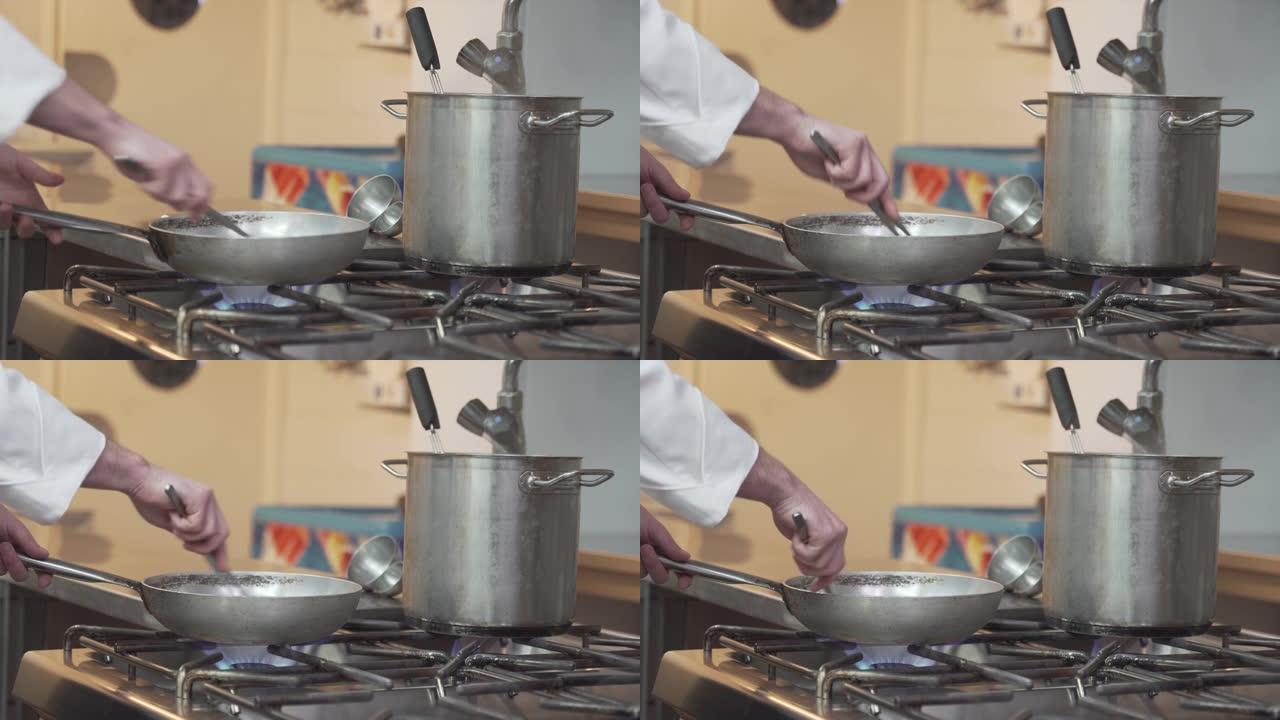 厨师在煤气炉上做饭的细节照片