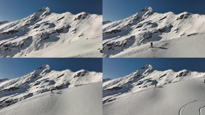 空中无人机拍摄了滑雪者在雪山上徒步旅行的镜头