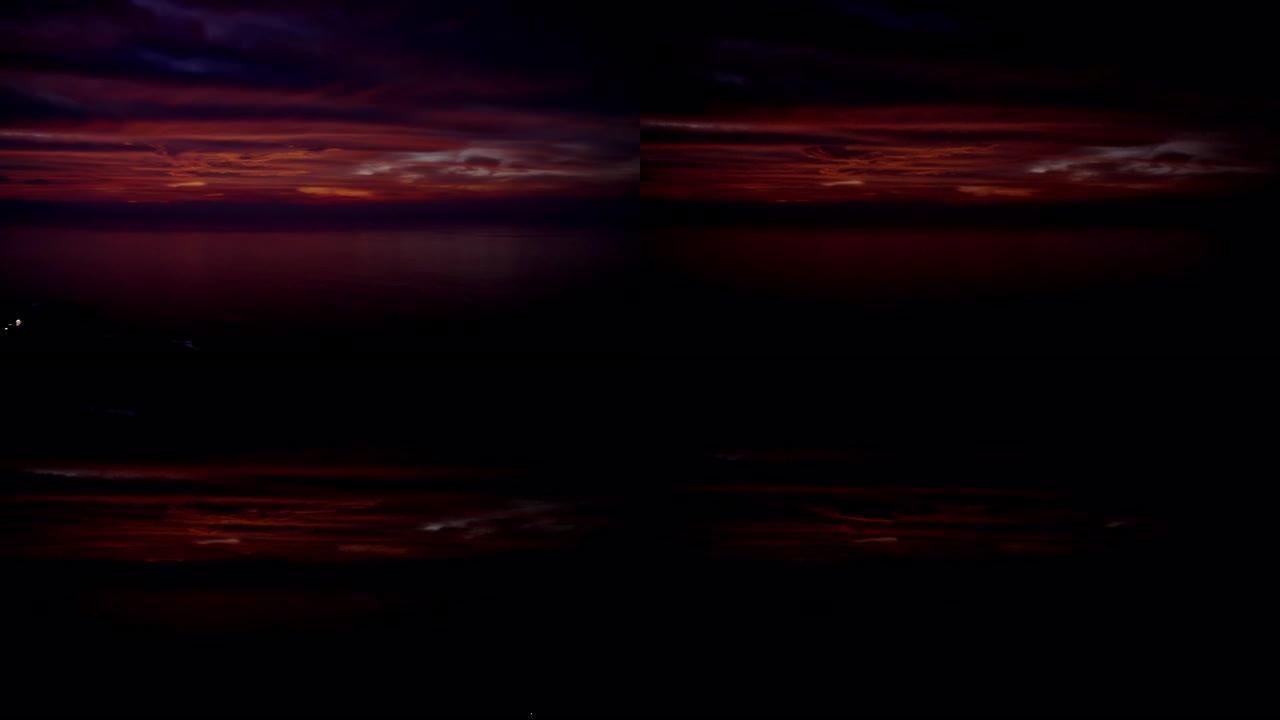 狂野的海洋海岸线，背景中的日落。戏剧性的，紫色的天空