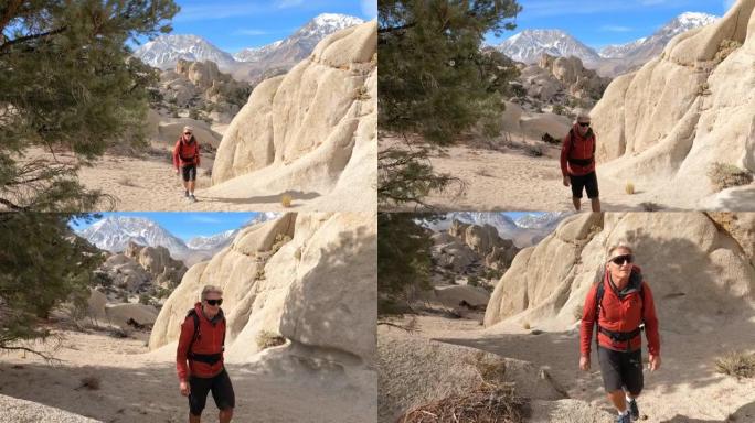 男性徒步旅行者通过岩石登上沙漠通道