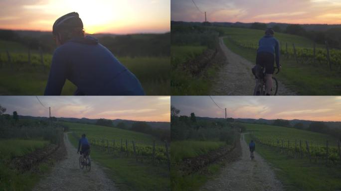 托斯卡纳日落时骑自行车探索碎石路和葡萄园的人