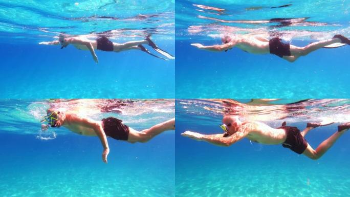 夏天在海里浮潜。男人在镜头前游泳。水下射击