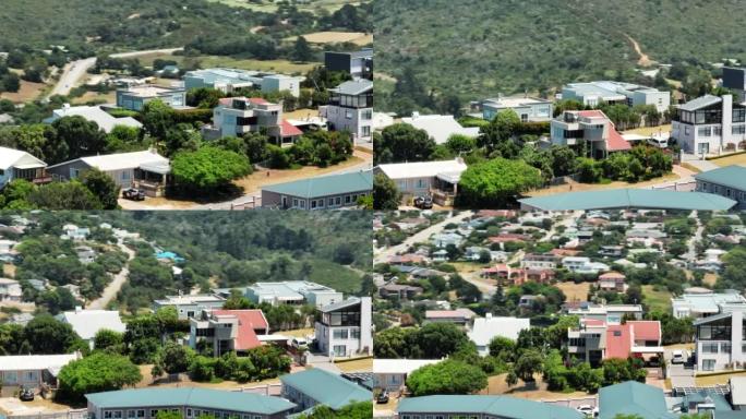 镇上居民的航拍画面。背景中建筑物和绿色植被的视差效应。南非