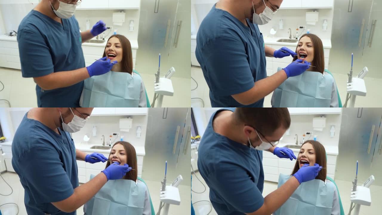 对女性患者进行口腔检查的男性牙医