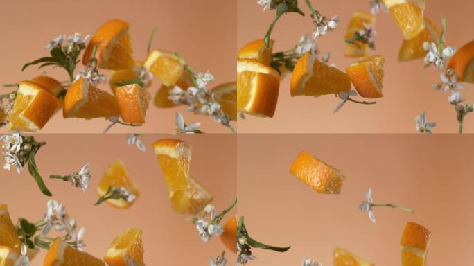 慢动作飞舞的橘子和花朵。用幻影弹性4k相机拍摄。
