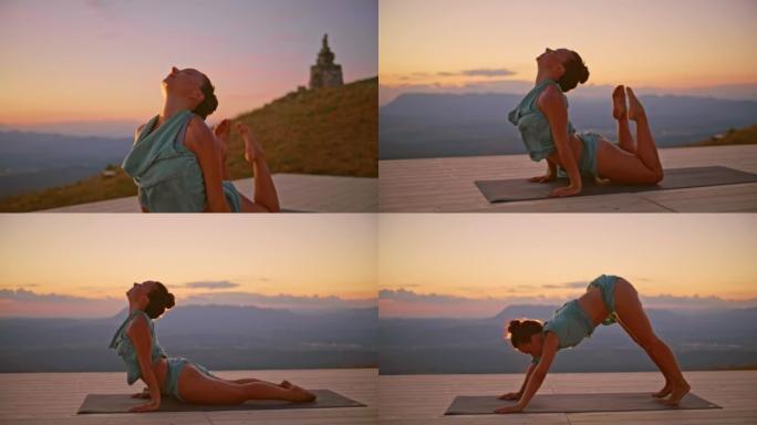 日出时在山上做瑜伽的SLO MO女人