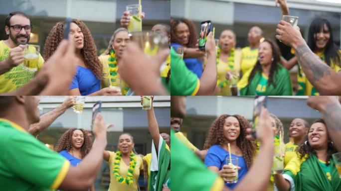 巴西体育迷在庆祝时在智能手机上拍摄