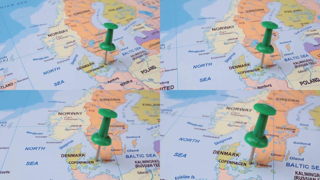 丹麦-世界地图上带有绿色图钉的旅行概念。地图上的定位点指向丹麦首都哥本哈根。