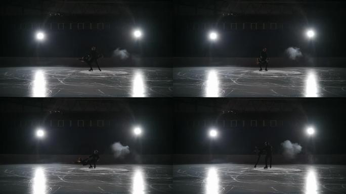 两名花样滑冰运动员在夜间在溜冰场上滑冰，运动型选手在空旷的竞技场上训练，慢动作射击，未来的冠军