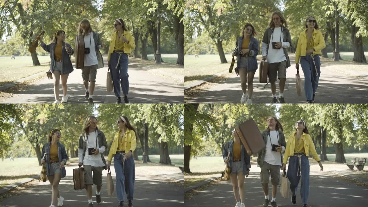 无忧无虑的20世纪60年代嬉皮士沿着阳光明媚的夏日道路行走并交谈。积极的高加索男女在户外旅行。反文化
