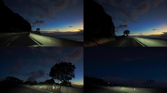 夜间在黑暗的山腰高速公路上行驶的汽车视点