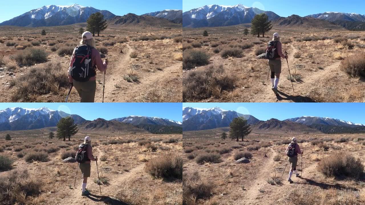 女徒步旅行者到达沙漠轨道的叉子，选择方向
