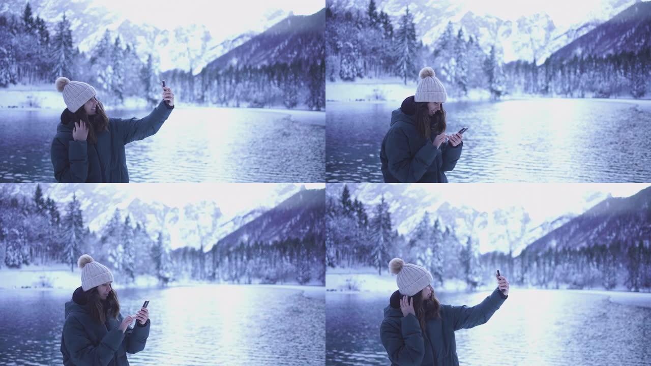 年轻女子在白雪皑皑的湖边自拍