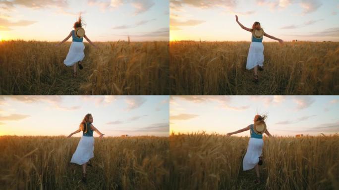 快乐的小女孩暑假在金色的麦田上奔跑，日落在乡下