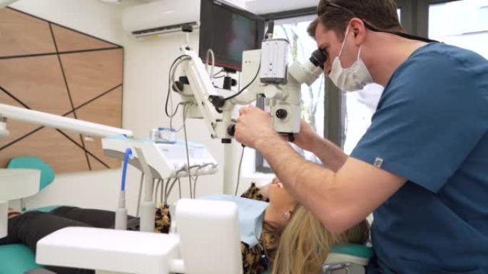 男性牙医使用牙科显微镜以获得更清晰和更好的视野