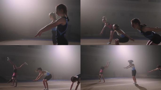 三名青少年女孩正在训练自由体操，准备参加艺术或艺术体操比赛