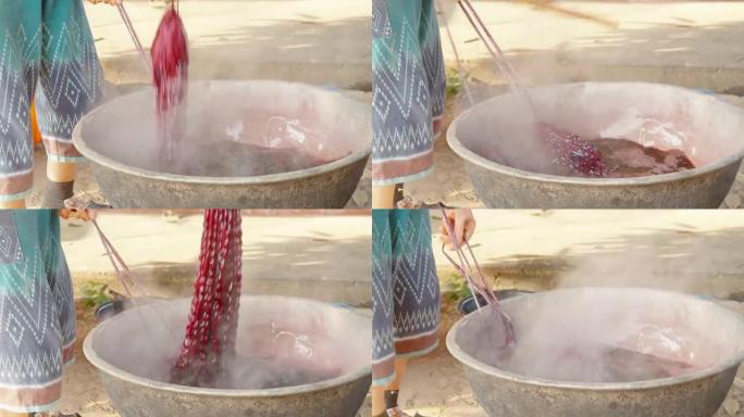 在泰国农村社区染色当地风格的泥浆布手工作品，丝织，编织产品。