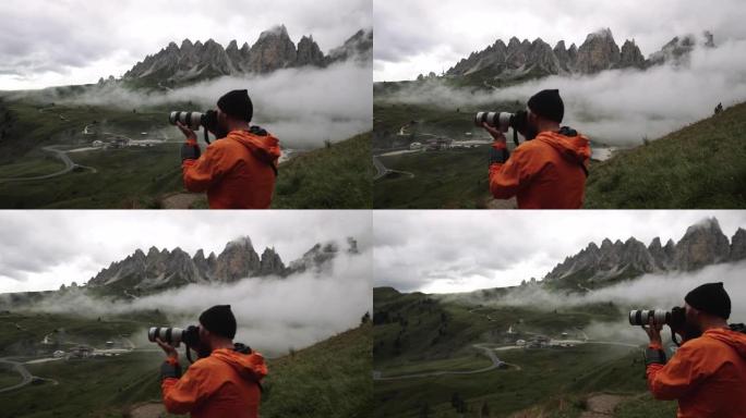 在寒冷的雾蒙蒙的日落中，男子摄影师在白云岩的高山上徒步旅行