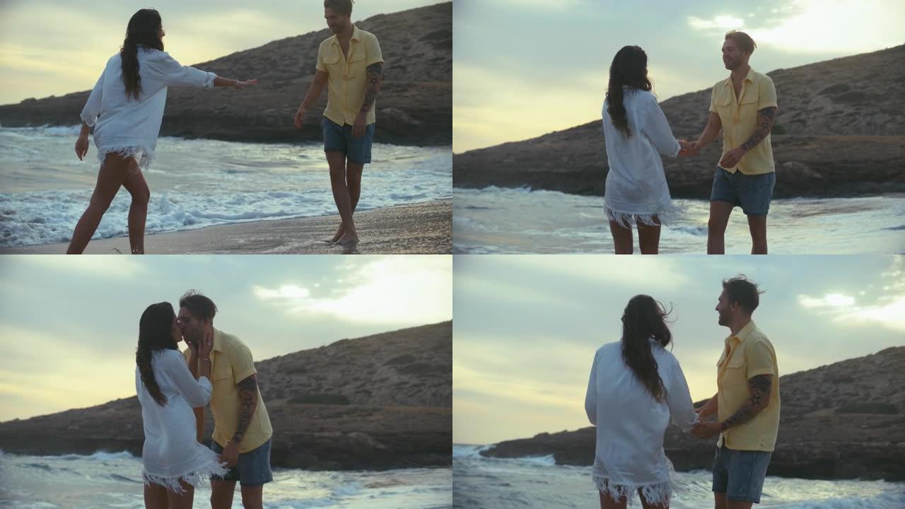 海滩上的浪漫情侣。相爱的情侣在日落时接吻