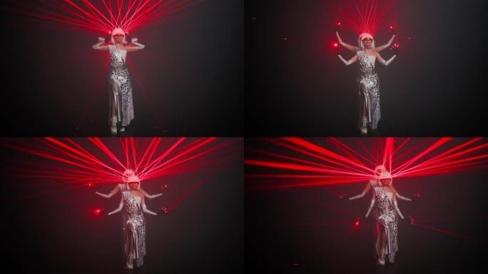 两名女子用眼镜上的红色激光束站在舞台上，一个接一个地跳舞。专业才华横溢的高加索自信舞者穿着未来派的网