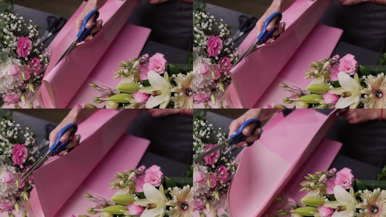 在花店工作的花卉艺术家。花卉创作插花。自上而下的视图。小女人经营理念，个体户。