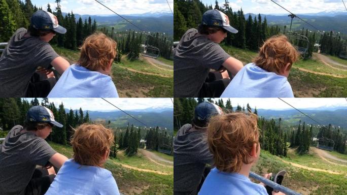 年轻男孩在不列颠哥伦比亚省华盛顿山上空乘坐升降椅