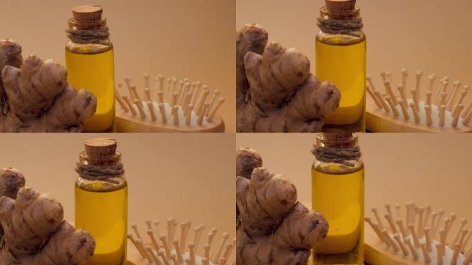 玻璃瓶的基本姜油，姜根在米色背景。健康的另类生活。用于头发护理的天然化妆品成分。健康生态梳子自制发膜