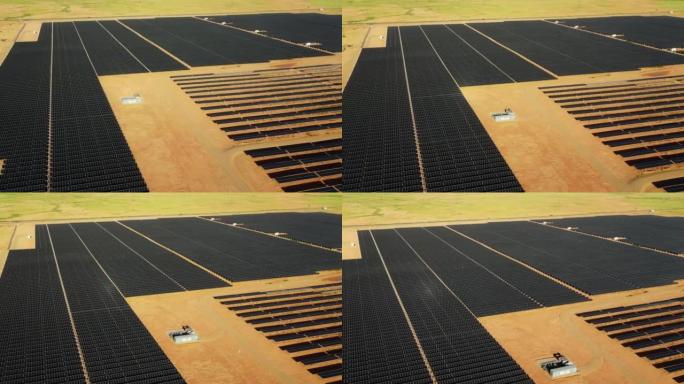 在纪念碑谷附近的亚利桑那州的太阳能农场的无人机空中飞行视图。通过太阳能电池板生产绿色能源