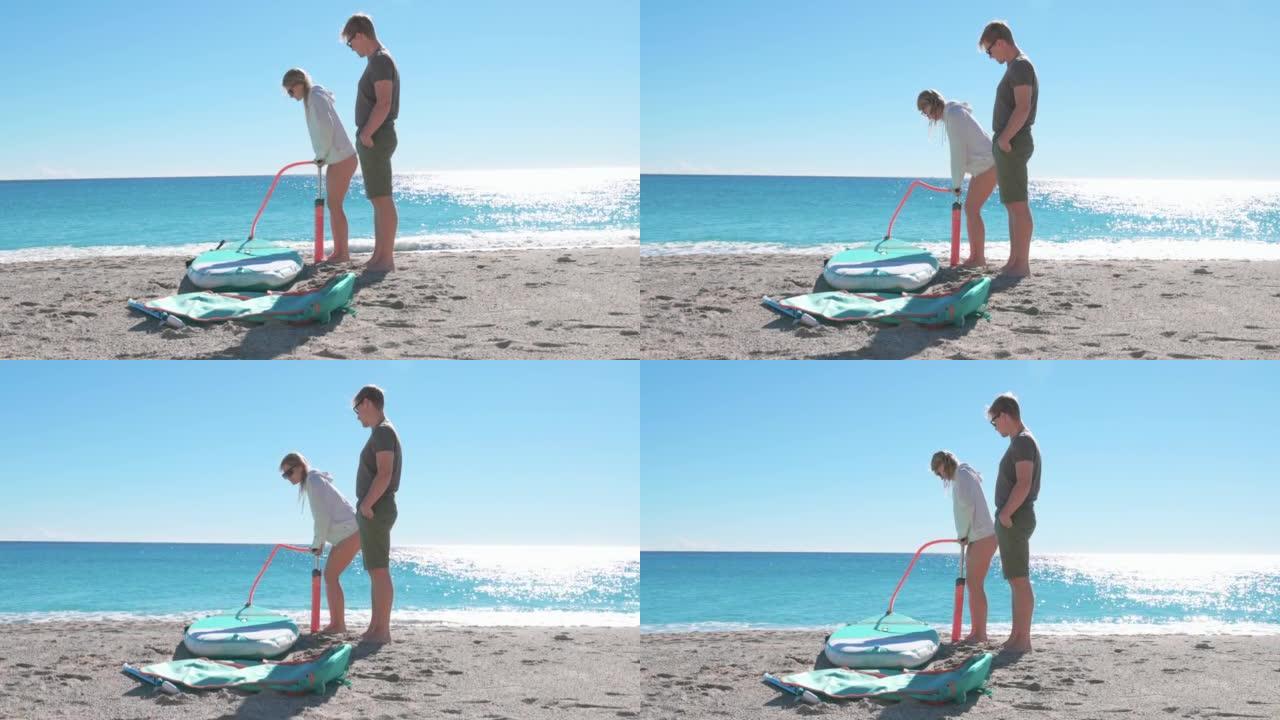 年轻男女在海滩上炸毁站立桨板 (SUP)
