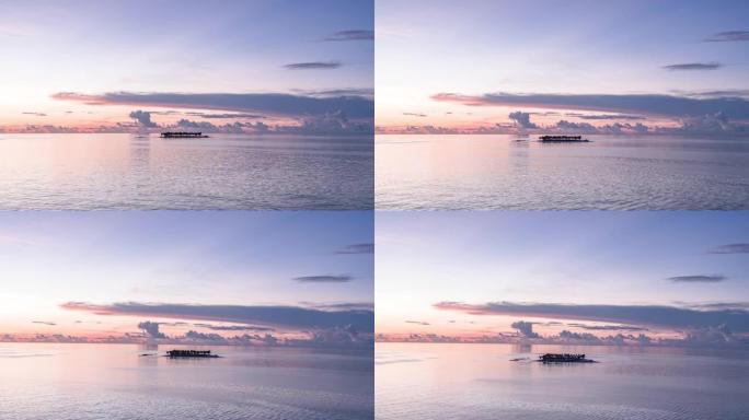 空中无人机拍摄日落时被海洋包围的小岛