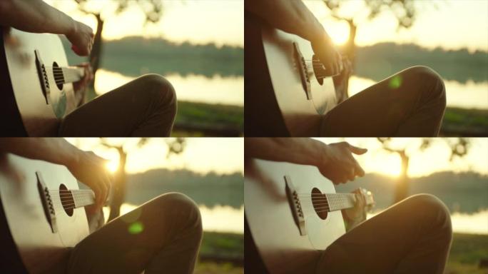 男子在日落灯光下弹吉他的特写镜头