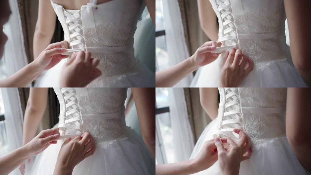 裁缝在身体周围测量，试穿婚纱。