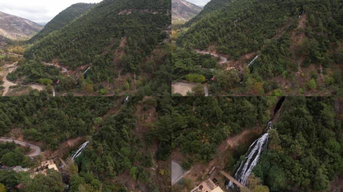 空中无人机拍摄隐藏在山坡上的瀑布